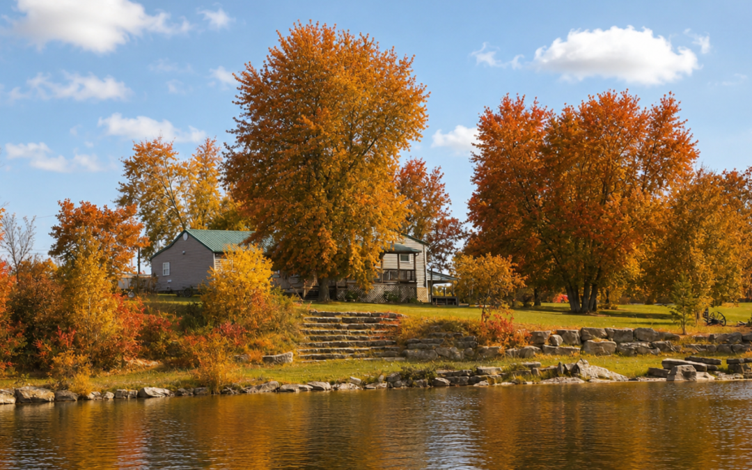 Fall colors around a lakeside retreat in Missouri with cabin, trees, and reflections on the water.